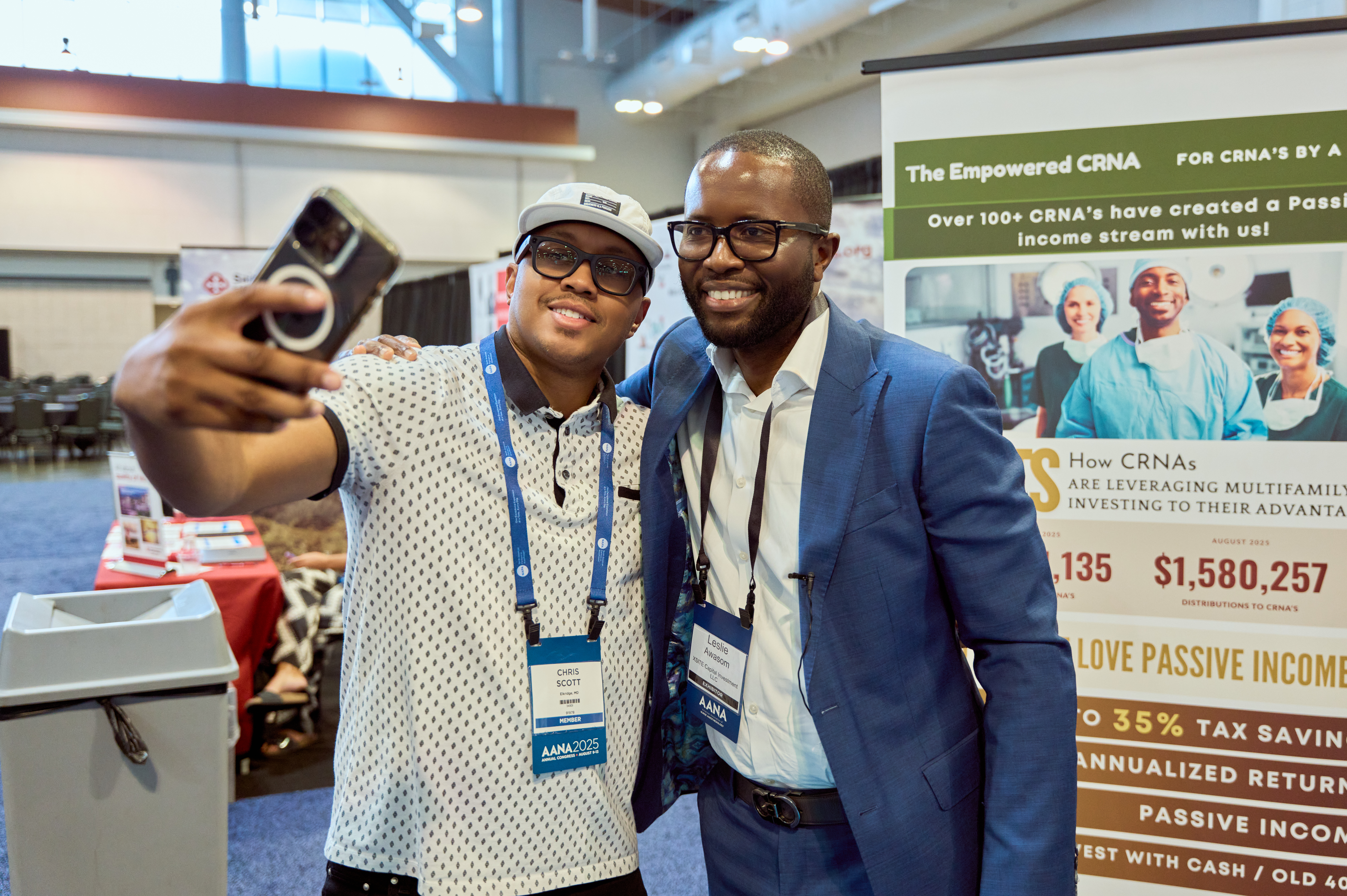 Community member with Leslie Awasom at the booth